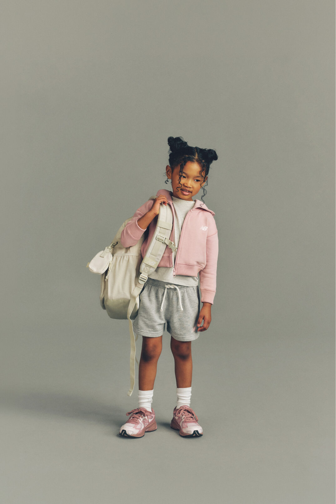 Child standing on a pile of books.