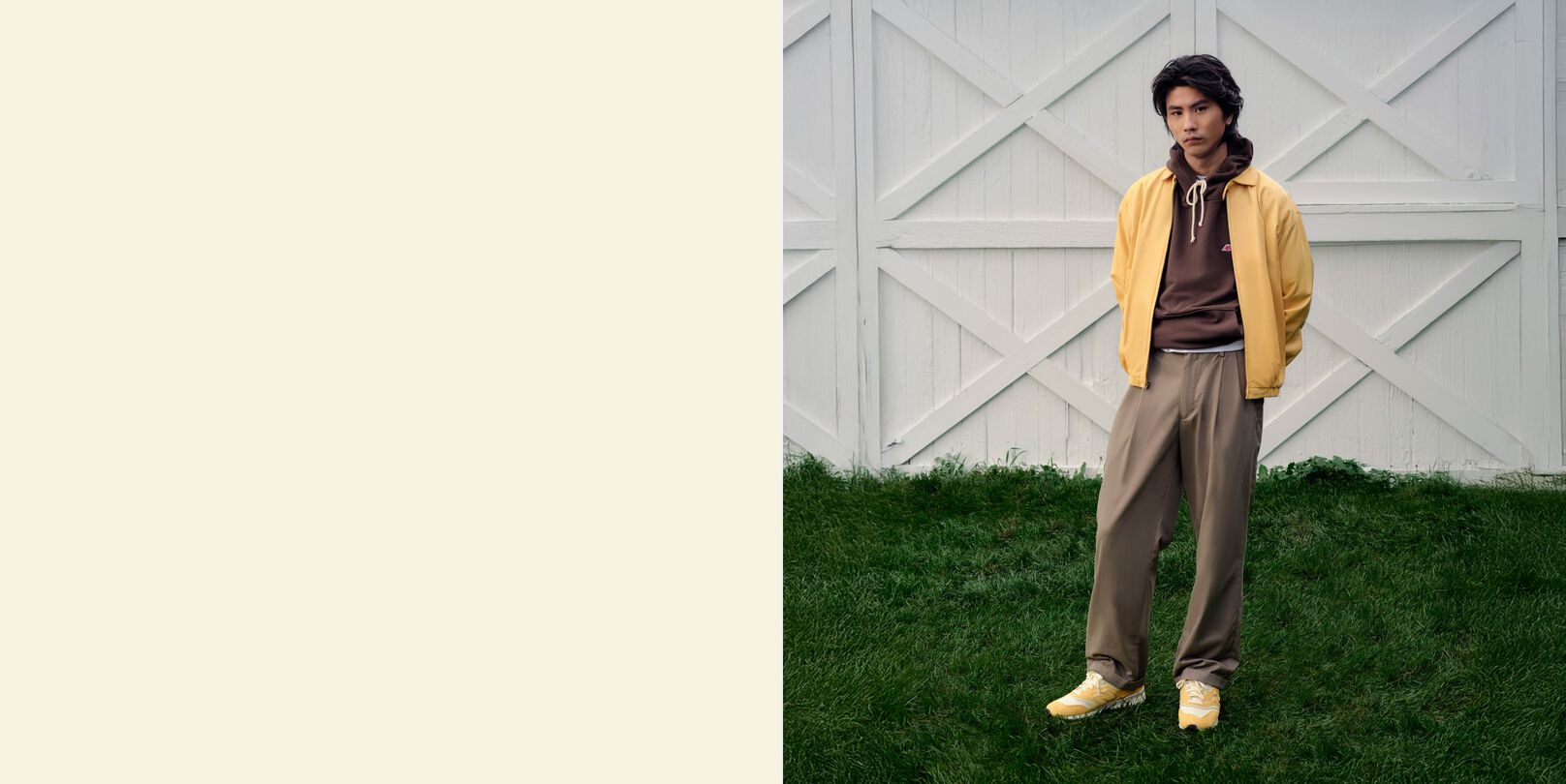 A man standing in front of a barn wearing New Balance shoes.